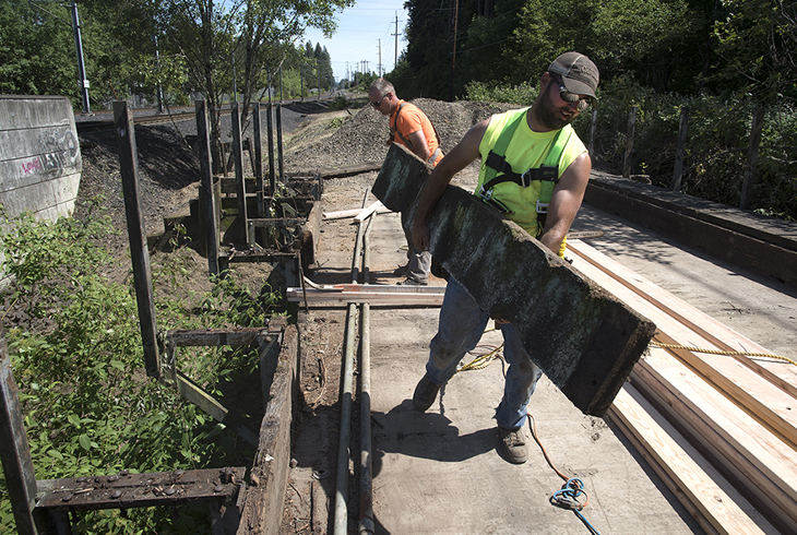 Workers for Benchmark Contracting prepare for structural upgrades to an old railroad trestle that will be part of the connection between the Westside Regional Trail and Waterhouse Trail.